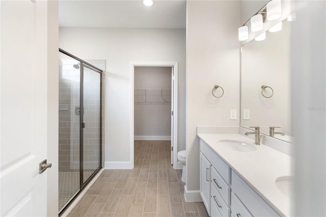 bathroom with vanity, an enclosed shower, and toilet