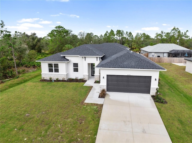 view of front of home featuring a front yard and a garage