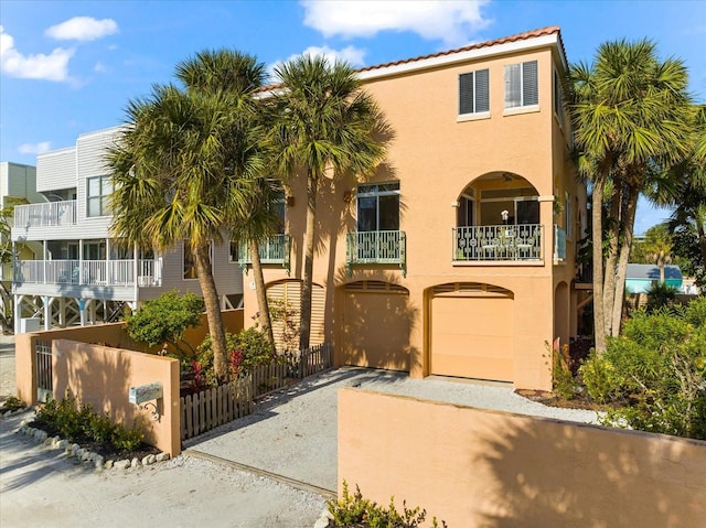 view of front of house with a garage and a balcony