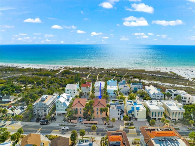 birds eye view of property with a view of the beach and a water view