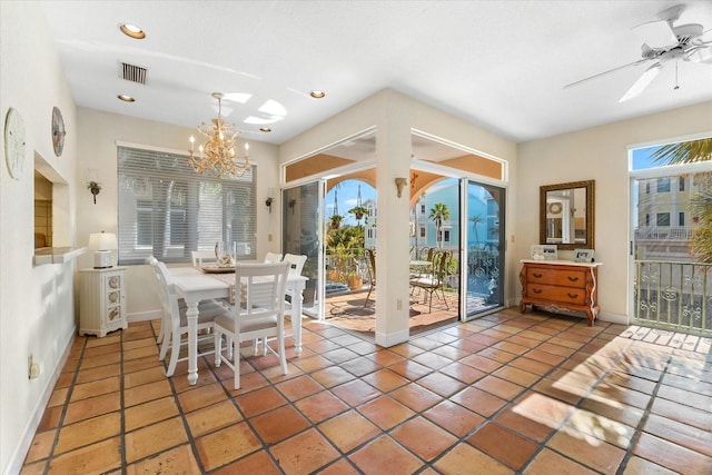 tiled dining room with ceiling fan with notable chandelier