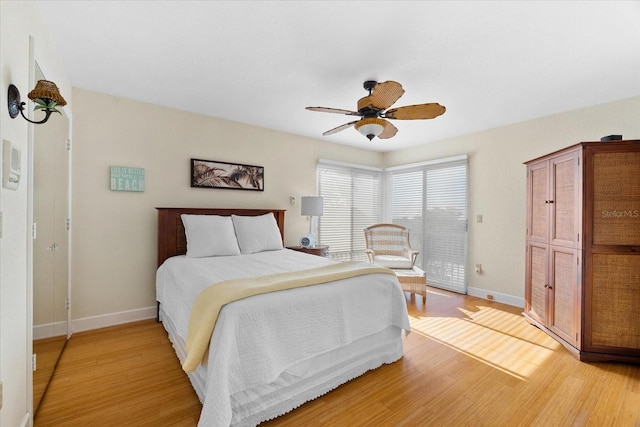 bedroom with ceiling fan and light hardwood / wood-style floors