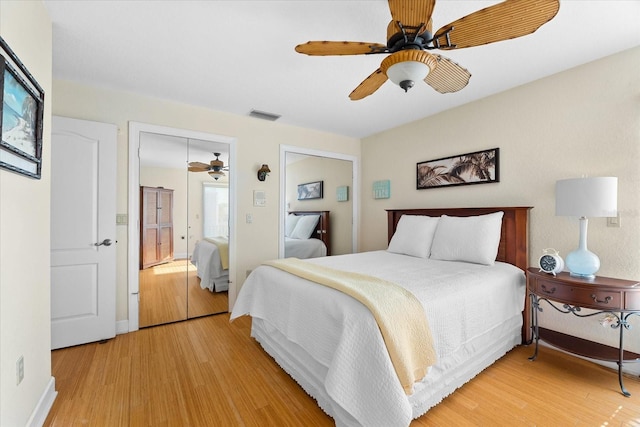 bedroom featuring light wood-type flooring, ceiling fan, and a closet