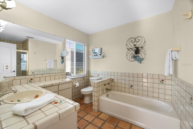 bathroom featuring tile patterned flooring, vanity, a tub, and toilet