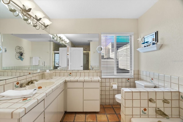 bathroom featuring tile patterned flooring, vanity, tile walls, and toilet