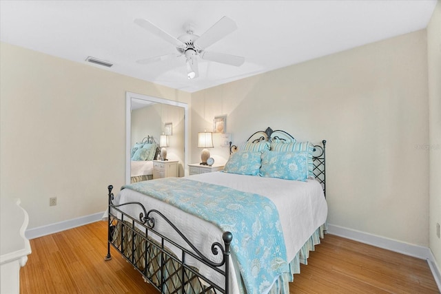 bedroom with ceiling fan and wood-type flooring