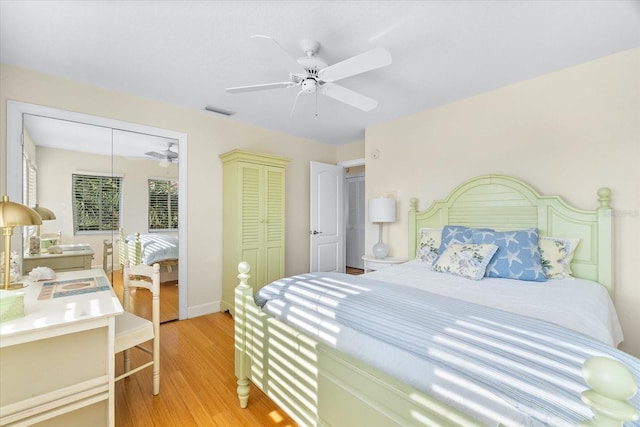 bedroom featuring ceiling fan, a closet, and light wood-type flooring