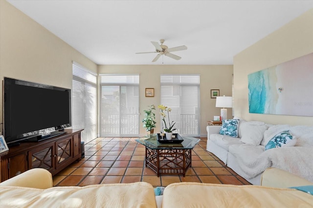 living room featuring ceiling fan and tile patterned flooring