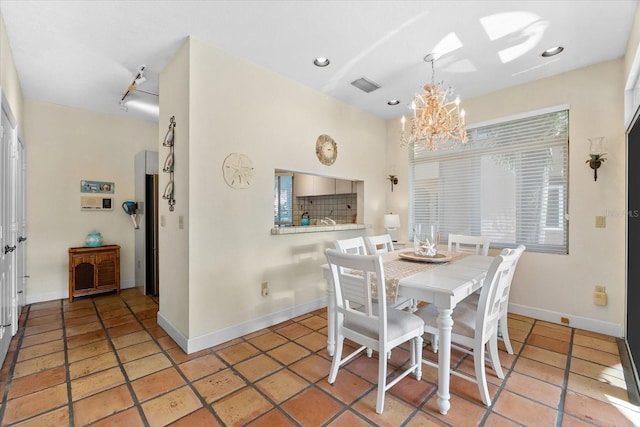 dining space featuring light tile patterned floors and a notable chandelier