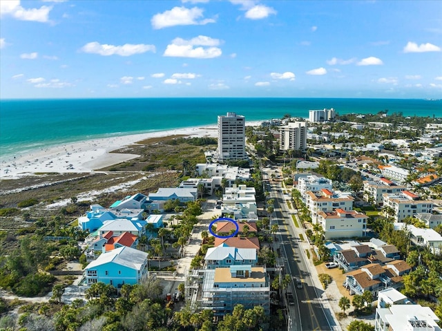 bird's eye view with a water view and a beach view