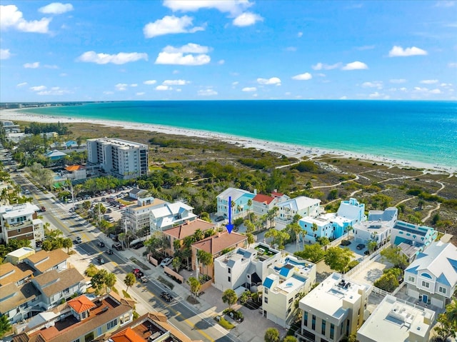 bird's eye view featuring a water view and a beach view