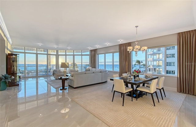 dining room with a water view, floor to ceiling windows, and a chandelier