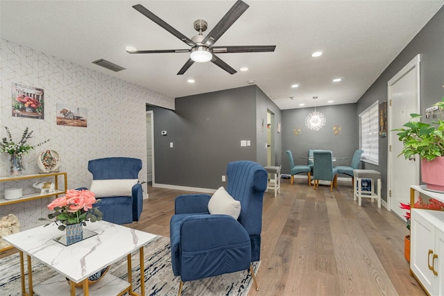 interior space featuring ceiling fan, light hardwood / wood-style flooring, and a textured ceiling