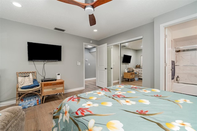 bedroom featuring light hardwood / wood-style floors, a closet, and ceiling fan