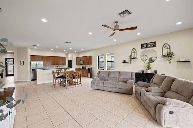 tiled living room with ceiling fan