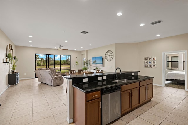 kitchen featuring a center island with sink, sink, stainless steel dishwasher, ceiling fan, and light tile patterned floors