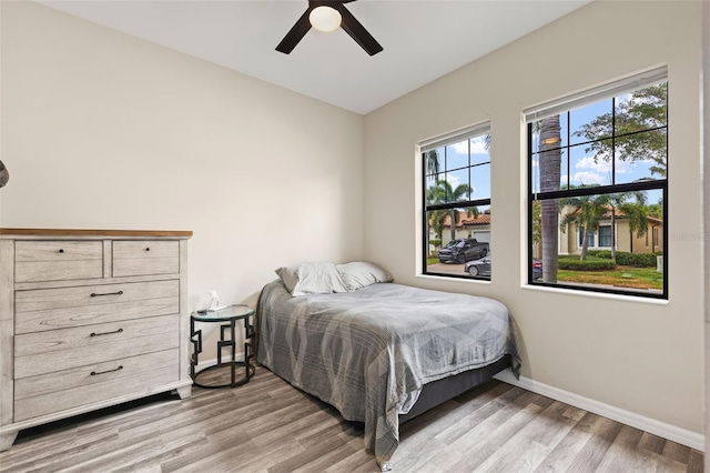 bedroom with light hardwood / wood-style floors and ceiling fan