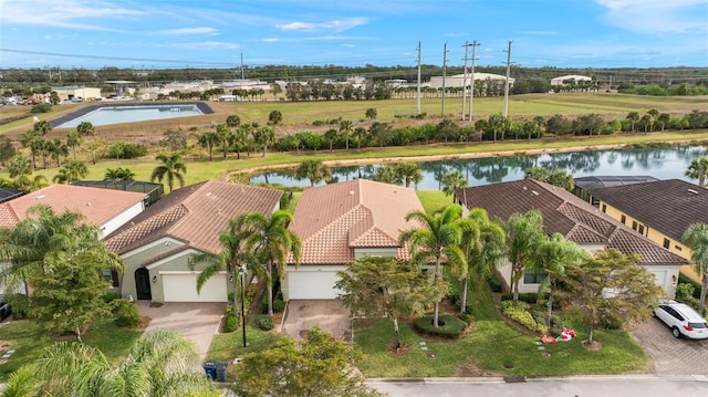 birds eye view of property with a water view