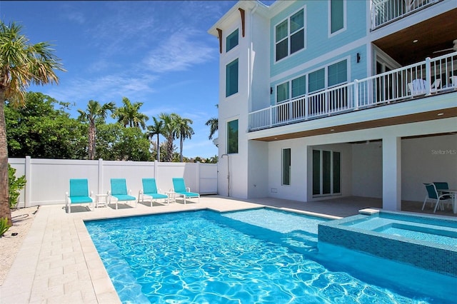 view of swimming pool featuring an in ground hot tub and a patio