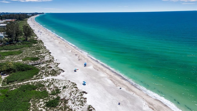 bird's eye view featuring a water view and a beach view