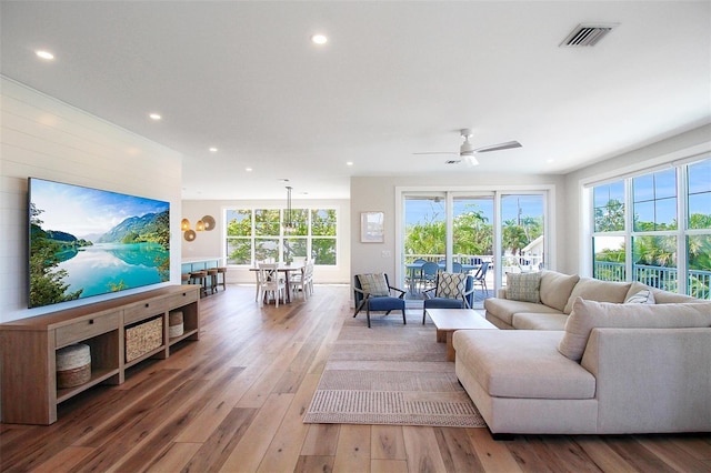 living room featuring ceiling fan and hardwood / wood-style floors