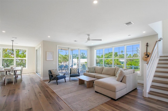 living room featuring hardwood / wood-style flooring and ceiling fan