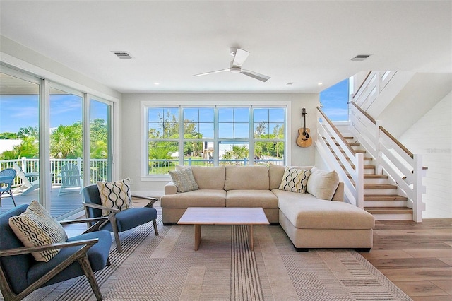 living room featuring ceiling fan and light hardwood / wood-style flooring