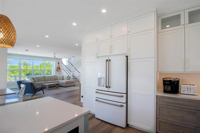 kitchen featuring white cabinets, dark hardwood / wood-style flooring, and high end white refrigerator