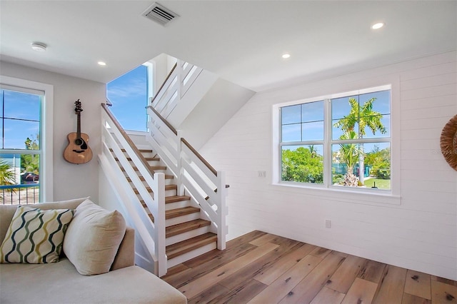 stairs with hardwood / wood-style flooring