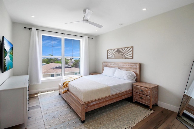 bedroom with ceiling fan and hardwood / wood-style flooring