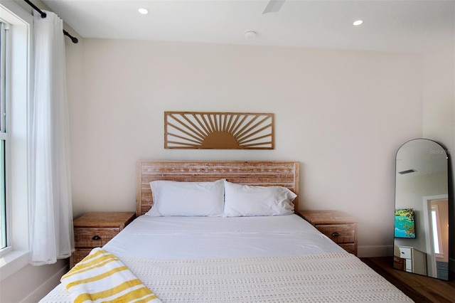 bedroom featuring ceiling fan and dark hardwood / wood-style floors