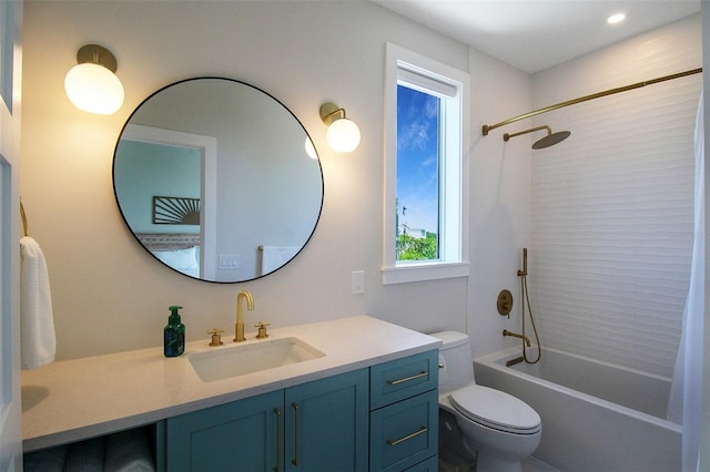 full bathroom with vanity, tiled shower / bath combo, and toilet