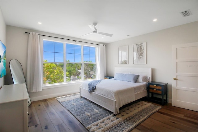 bedroom with ceiling fan and dark wood-type flooring