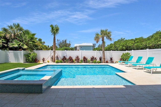 view of pool with a patio area and an in ground hot tub