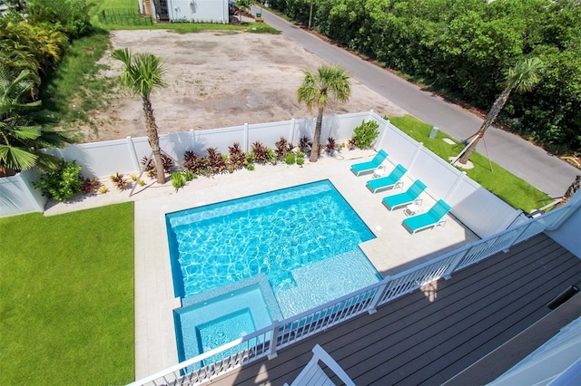 view of pool featuring a lawn and a wooden deck