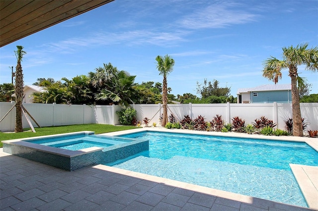 view of swimming pool with an in ground hot tub