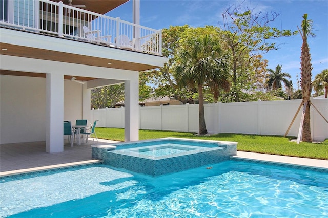 view of swimming pool featuring a patio area, a yard, ceiling fan, and an in ground hot tub