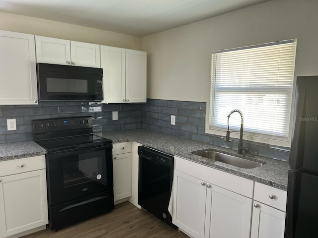 kitchen with backsplash, sink, white cabinets, and black appliances