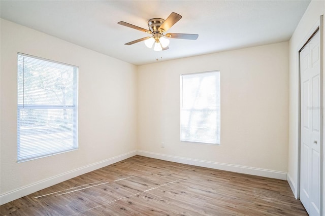 unfurnished bedroom with a closet, light hardwood / wood-style flooring, and ceiling fan