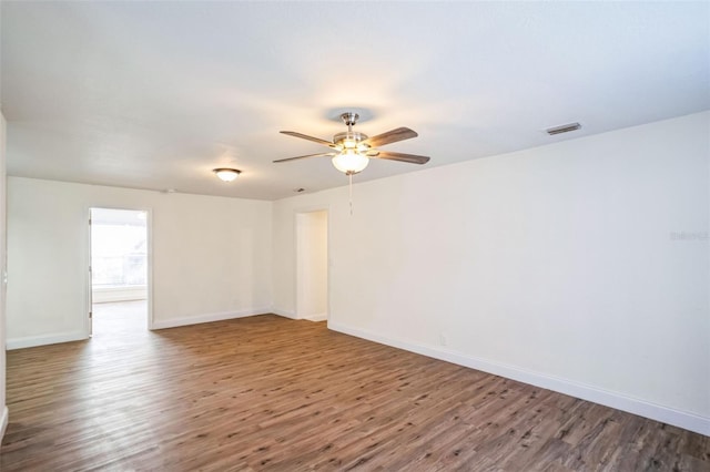 unfurnished room with ceiling fan and wood-type flooring