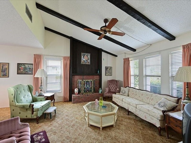 living room featuring carpet, a textured ceiling, ceiling fan, lofted ceiling with beams, and a fireplace