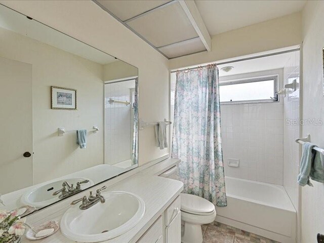 full bathroom featuring vanity, toilet, and shower / tub combo with curtain