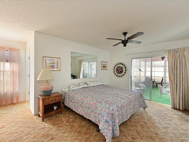 bedroom featuring carpet, ceiling fan, access to exterior, and a textured ceiling