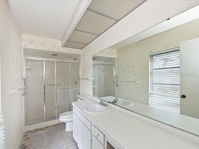 bathroom featuring vanity, toilet, and walk in shower