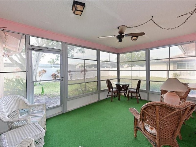 sunroom / solarium featuring ceiling fan