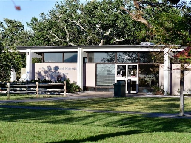 rear view of house with a lawn