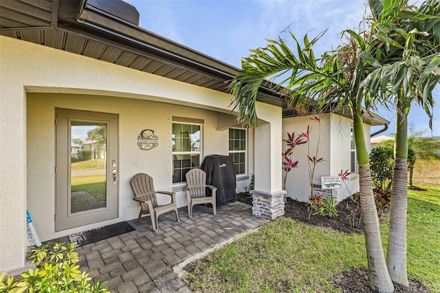 doorway to property with a patio area