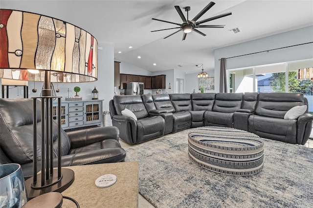 living room with ceiling fan and vaulted ceiling