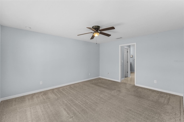 spare room featuring ceiling fan and light colored carpet