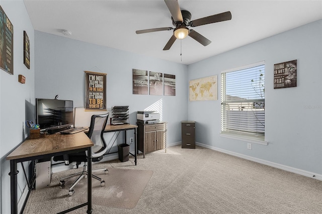 home office featuring ceiling fan and light carpet